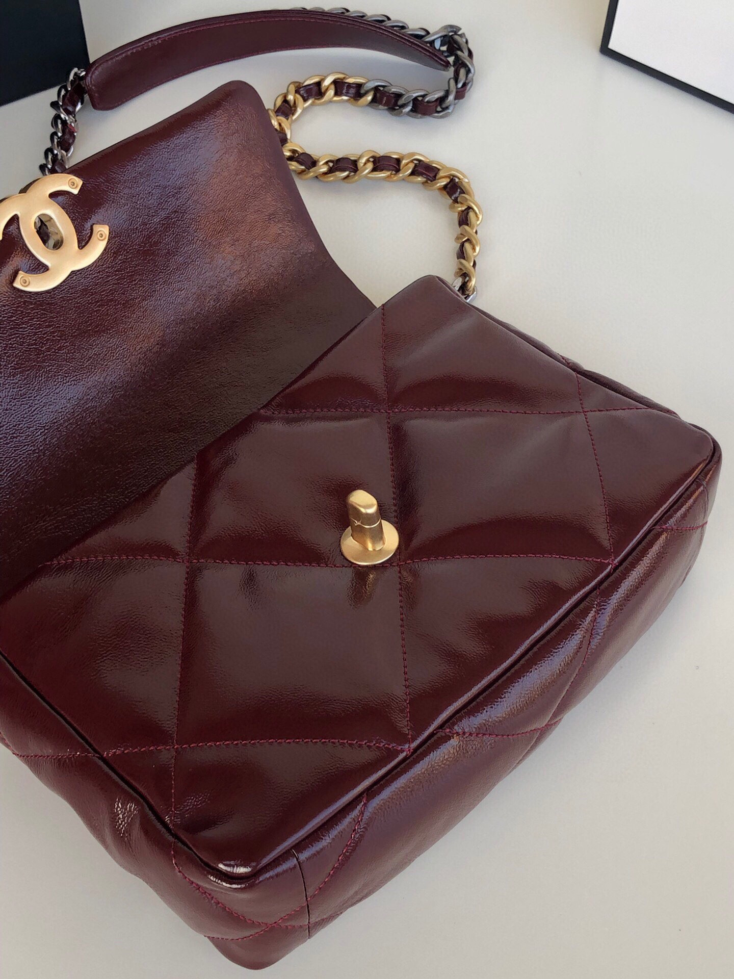 Ch*el 19 handbag shiny leather, gold-tone, silver-tone & ruthenium-finish metal dark red 6.2 × 10.1 × 3.5 in